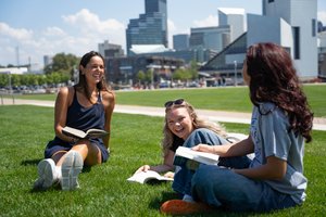 Students Reading Textbooks on Grass