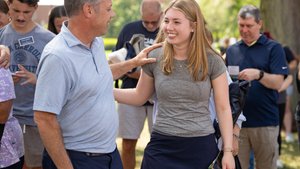 Man Light Blue Shirt Smiles Touches Shoulder Smiling