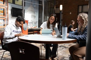 Three Students Sit Around Round Table Working Laptops 1281