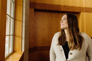 Woman Beige Cardigan Looking Out Window